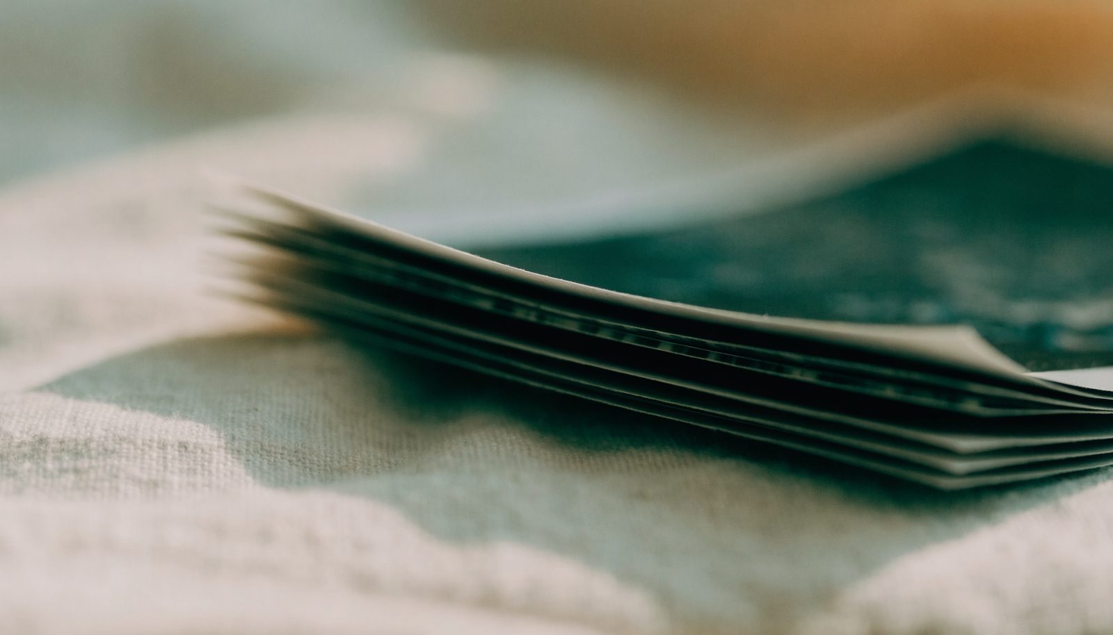 A stack of printed photographs on linen