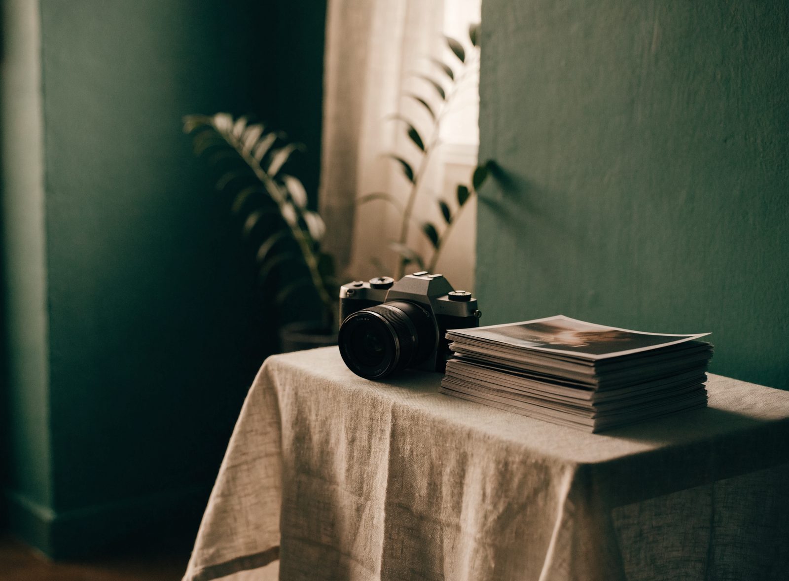 A camera and printed photographs in a photographer's studio